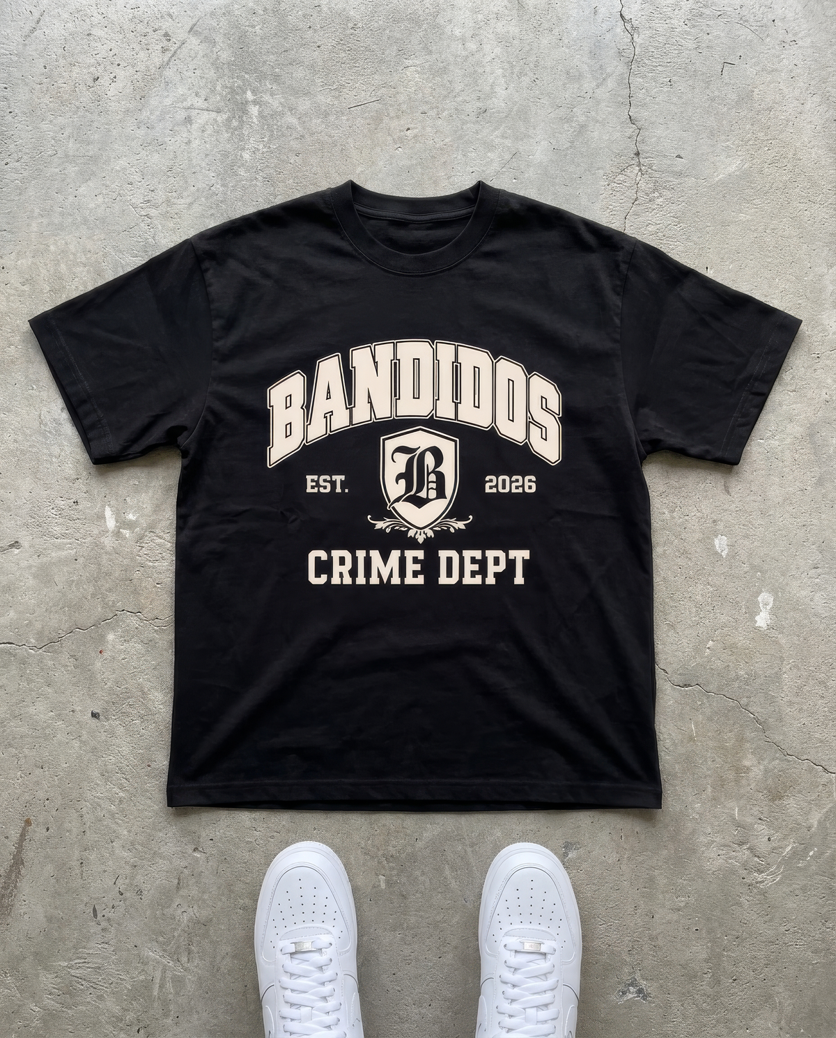 BANDIDOS CRIME DEPT TEE – BLACK laid flat on concrete