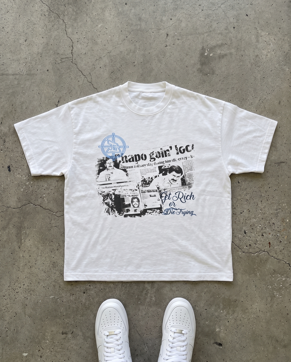 BANDIDOS PABLO TEE laid flat on concrete – white tee with newspaper clipping collage graphic and blue "Get Rich or Die Trying" script